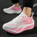 White and pink running shoes on a black surface